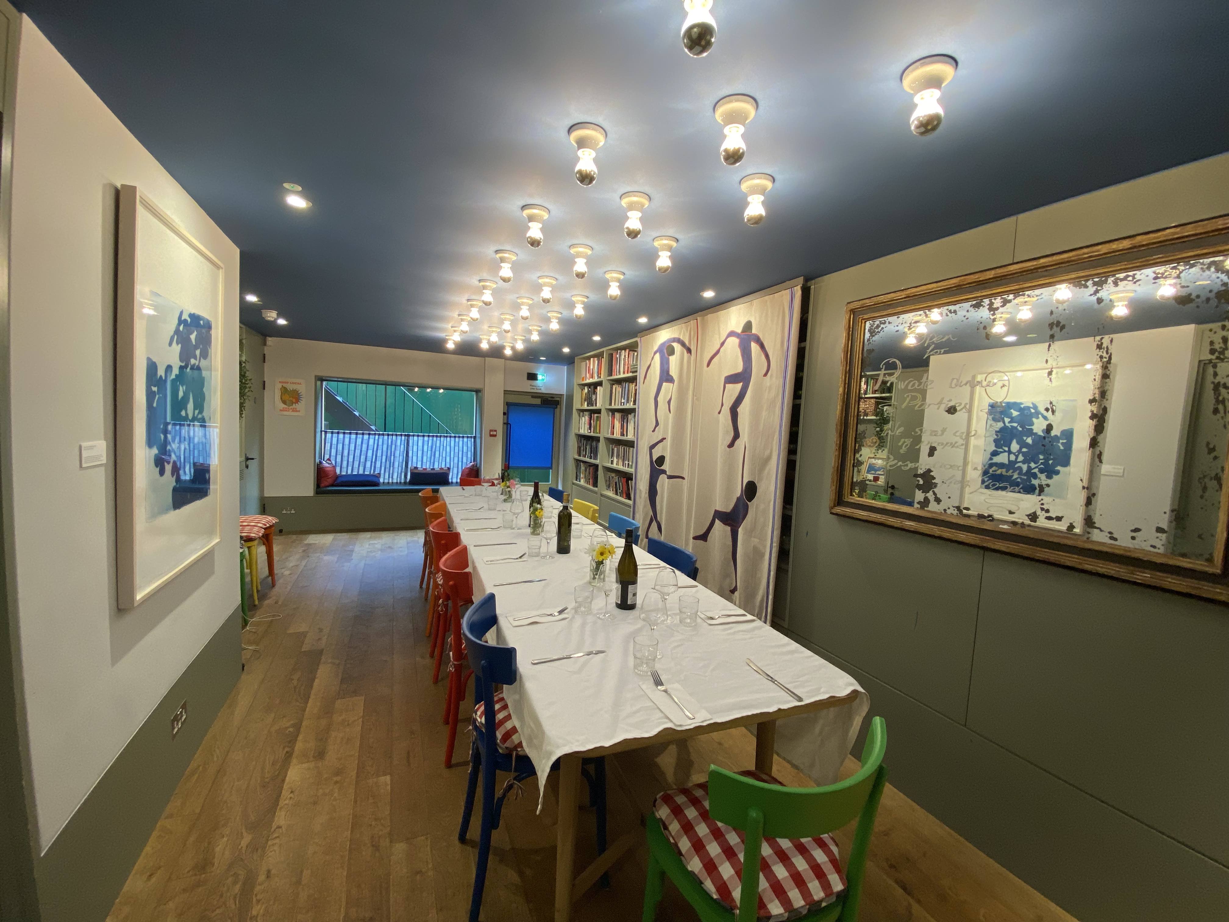 Private dining room at Sam's Cafe with colorful chairs, ideal for meetings and gatherings.