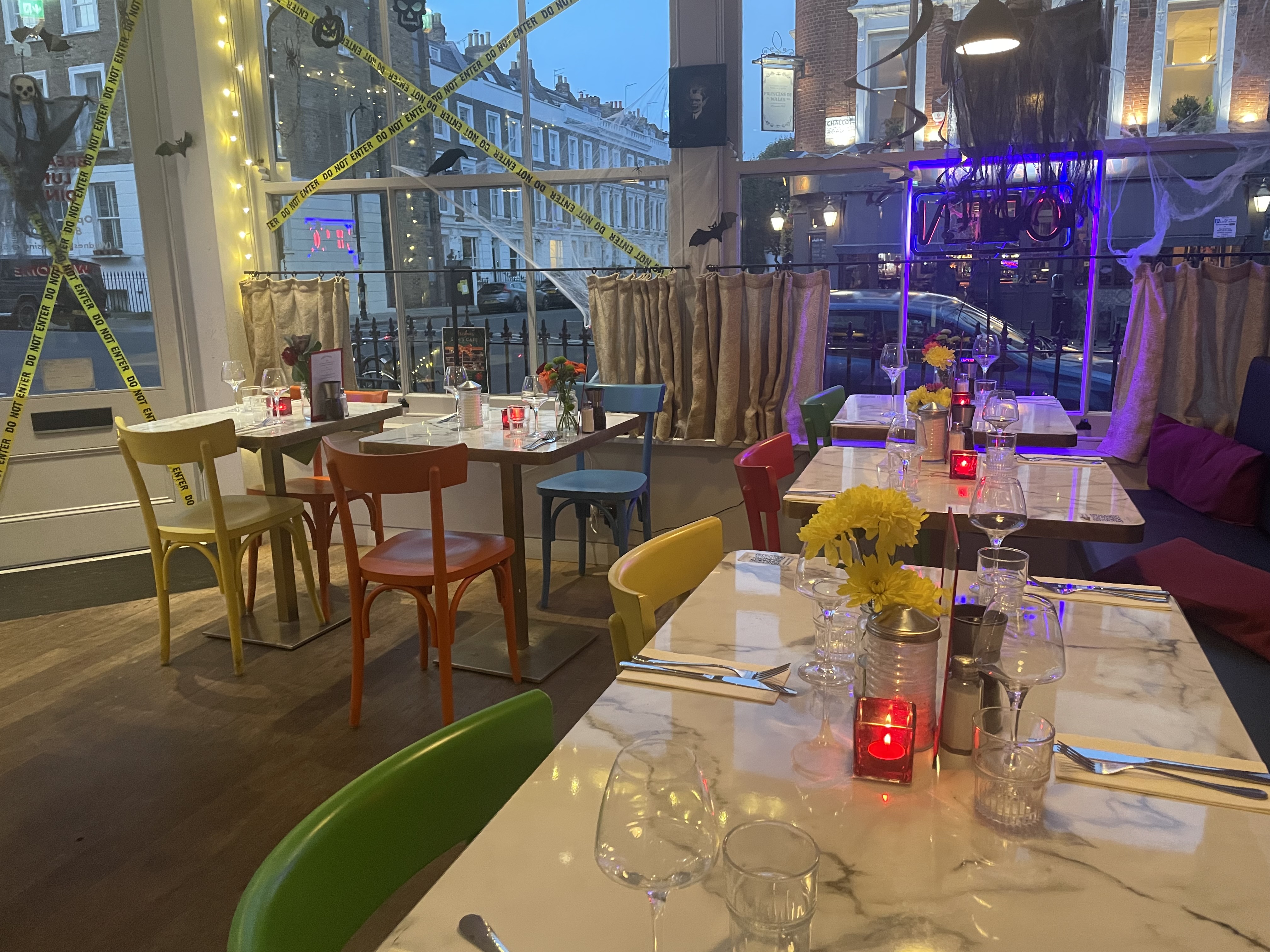 Vibrant restaurant with colorful chairs, ideal for intimate gatherings and creative events.