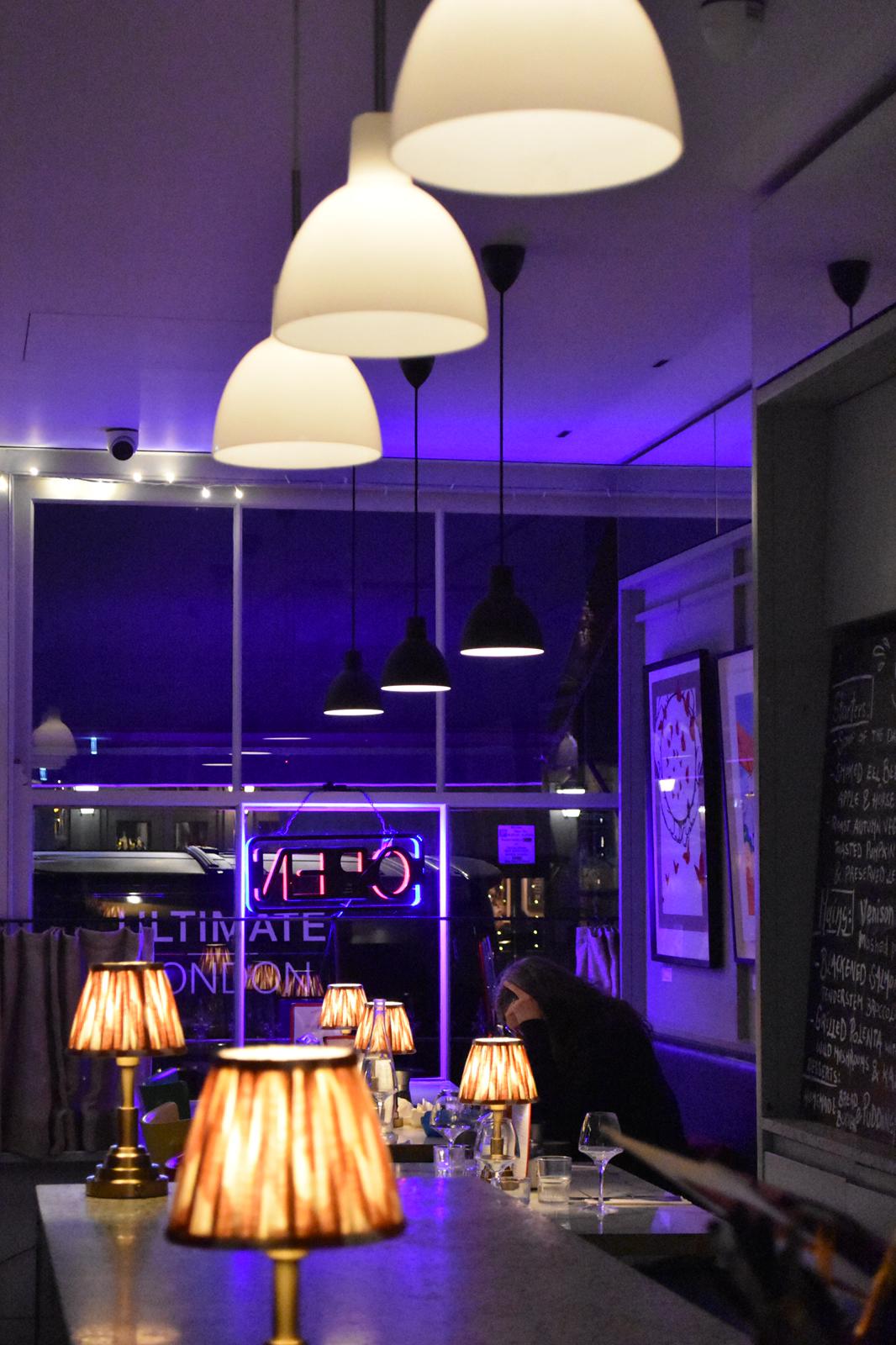 Modern event space at Sam's Cafe with ambient lighting, ideal for networking and gatherings.