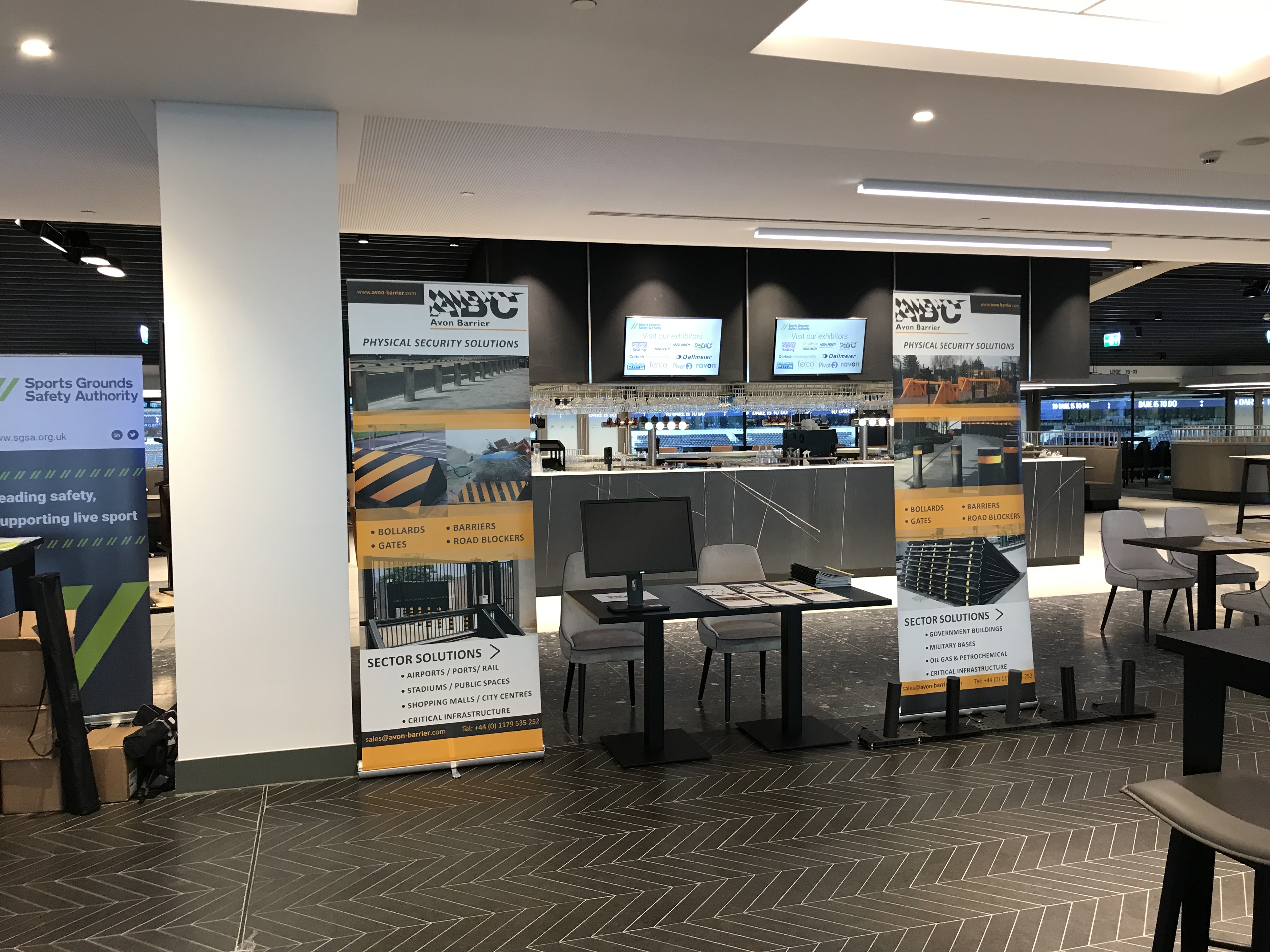 Event space with branded banners and screens in Tottenham Hotspur Stadium for meetings.