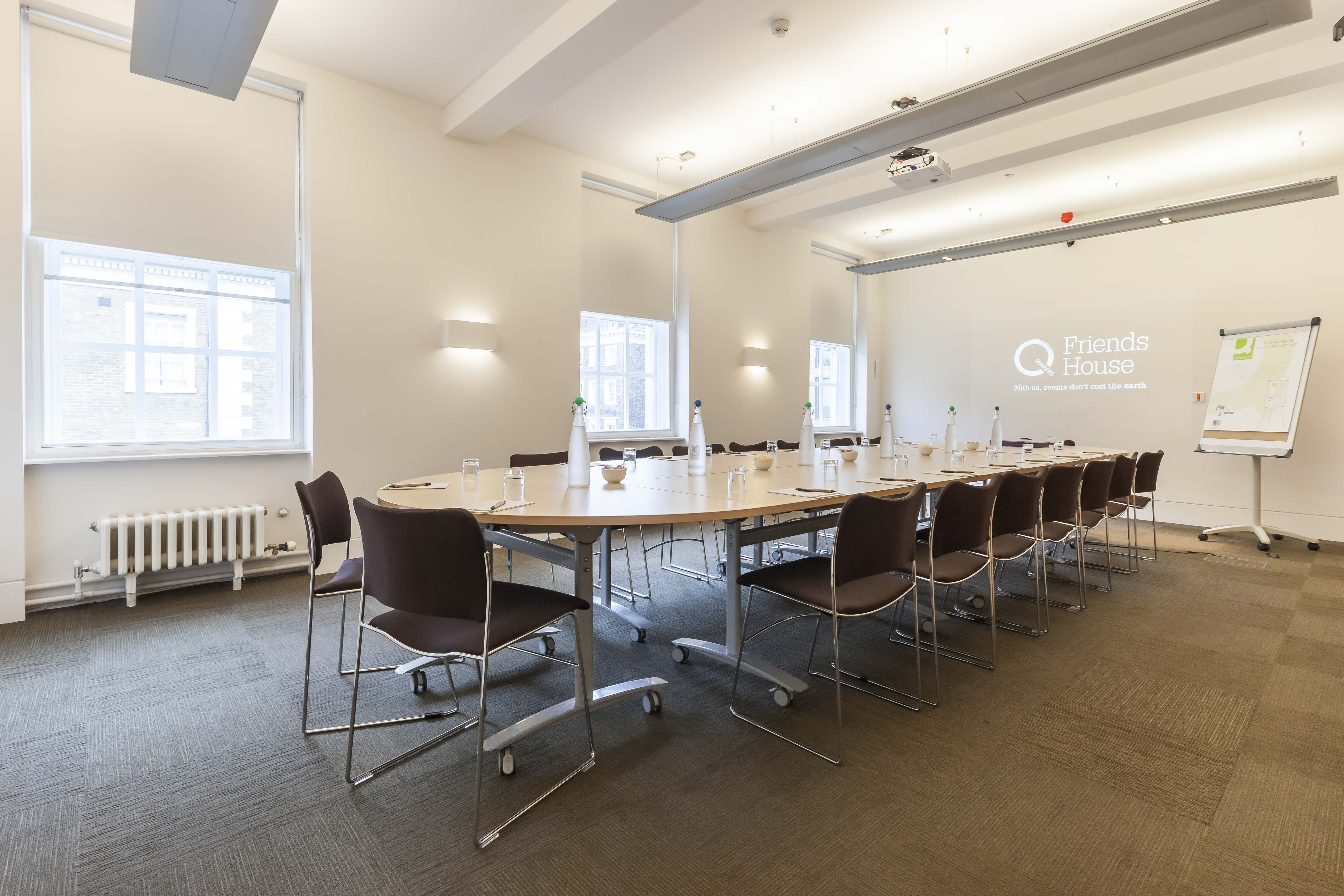Margaret Fell in a modern meeting room with a circular table for collaborative sessions.