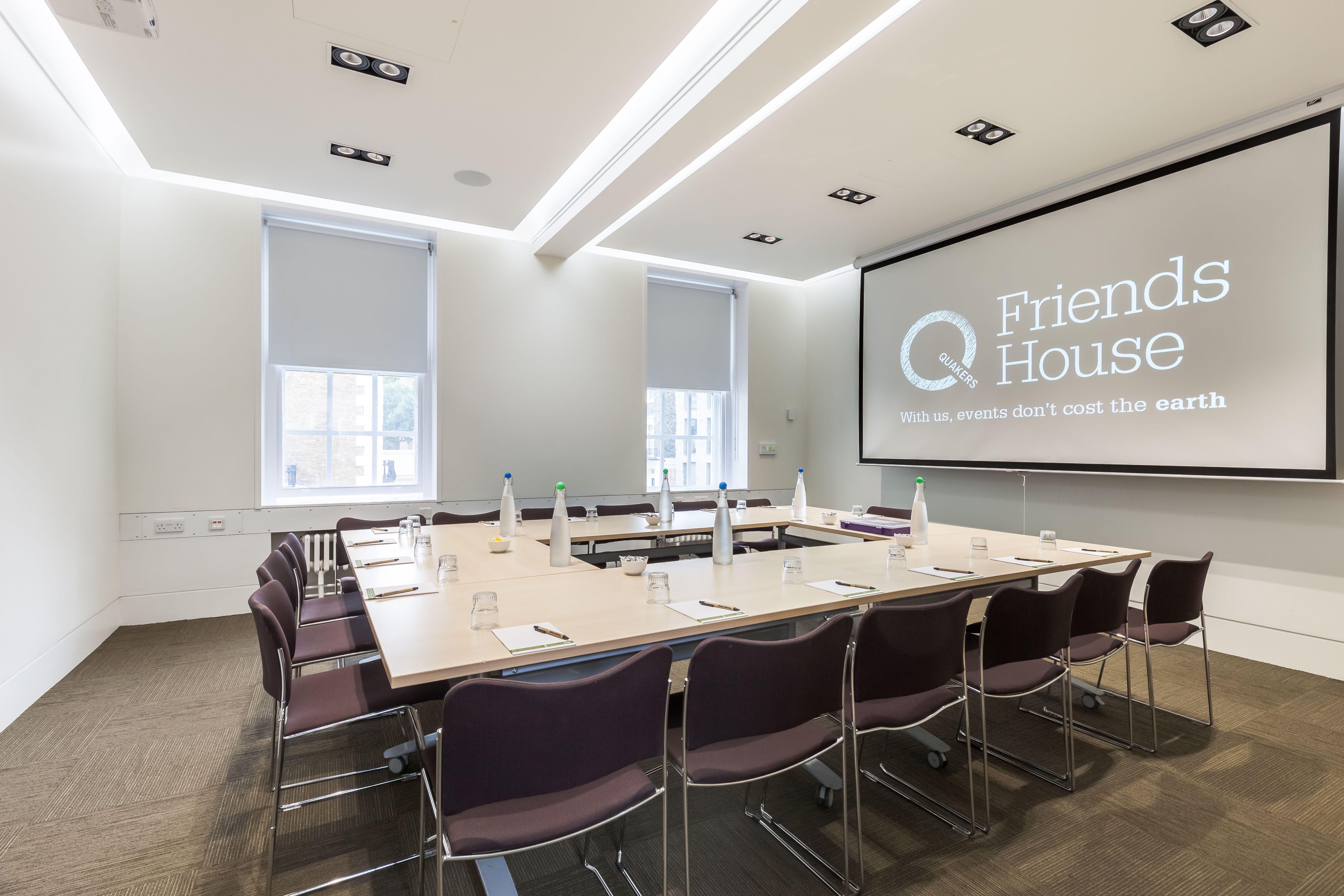 Modern meeting room with large table, ideal for professional gatherings and presentations.