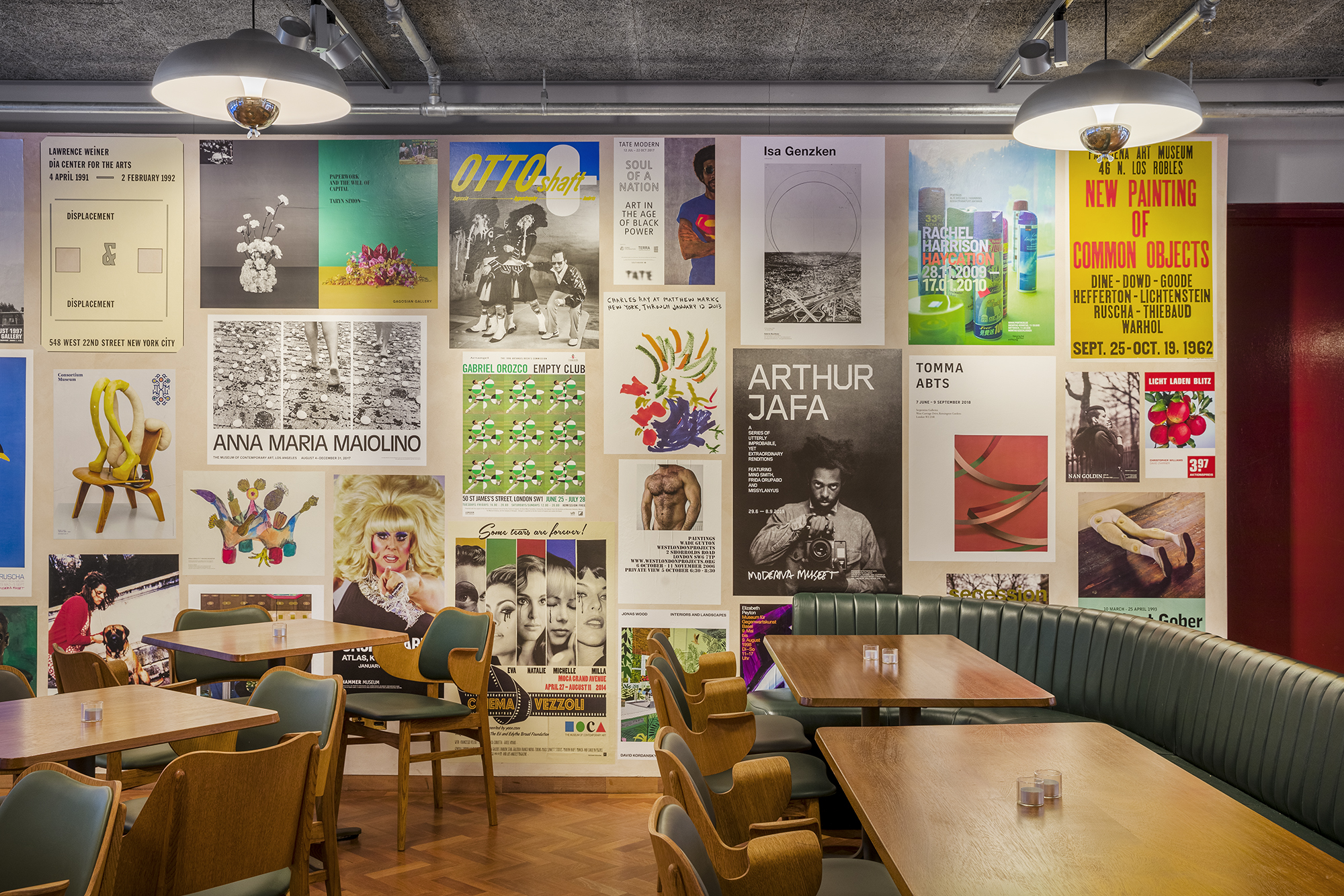 Eclectic art wall in Toklas Restaurant's Bar Room, perfect for creative meetings and events.