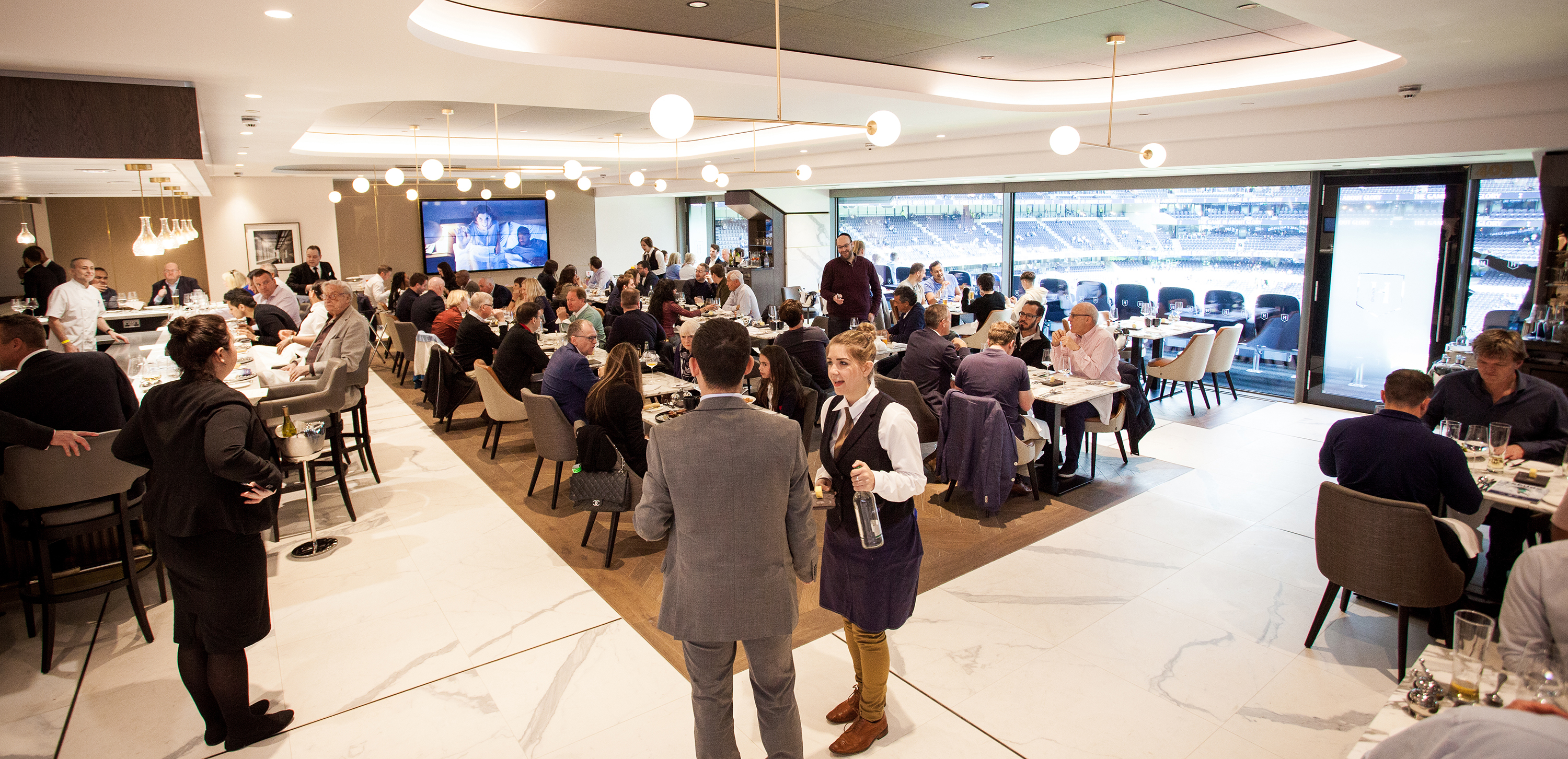 Vibrant meeting space at The H Club, Tottenham Hotspur Stadium for corporate networking events.