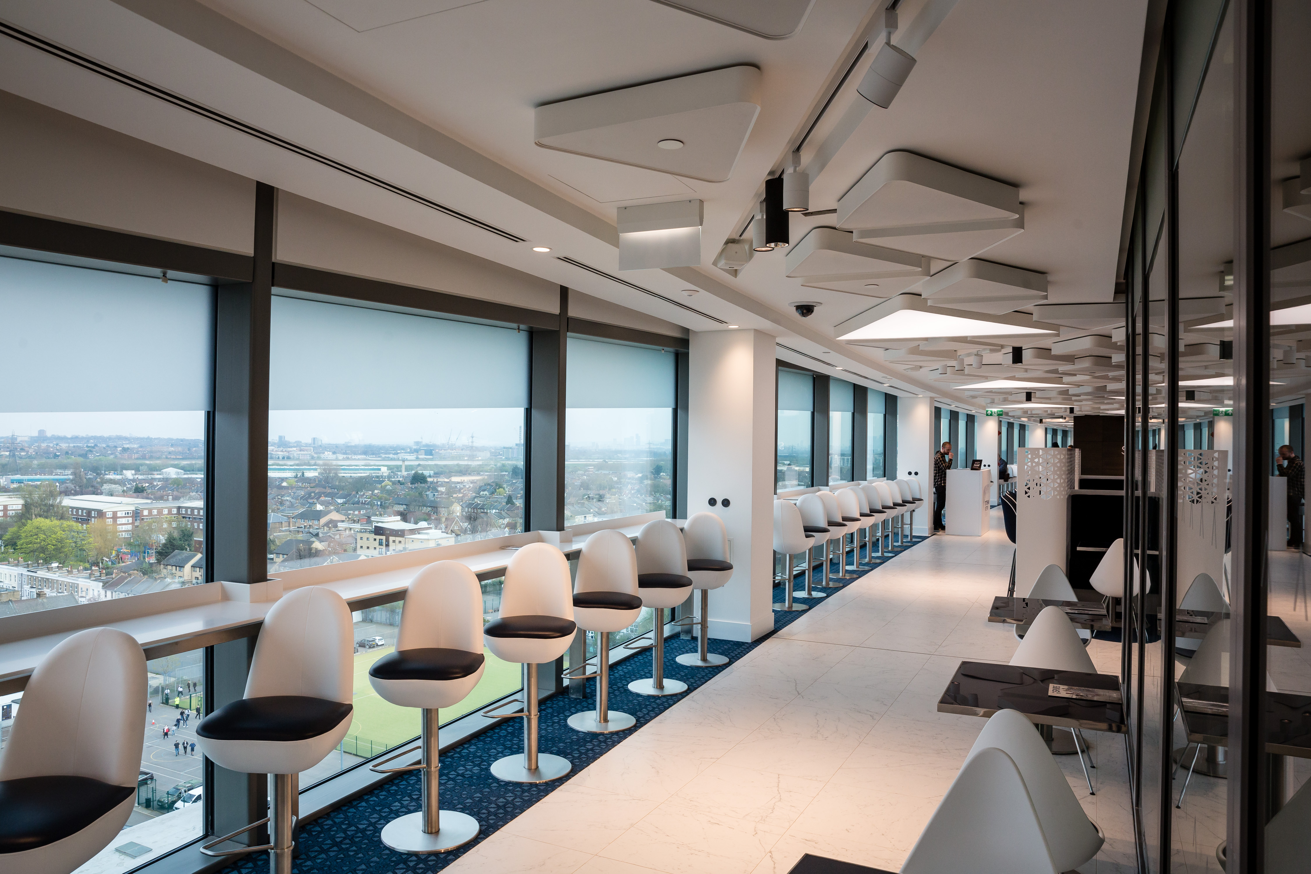 Sleek event space with panoramic windows at Tottenham Hotspur Stadium for corporate gatherings.