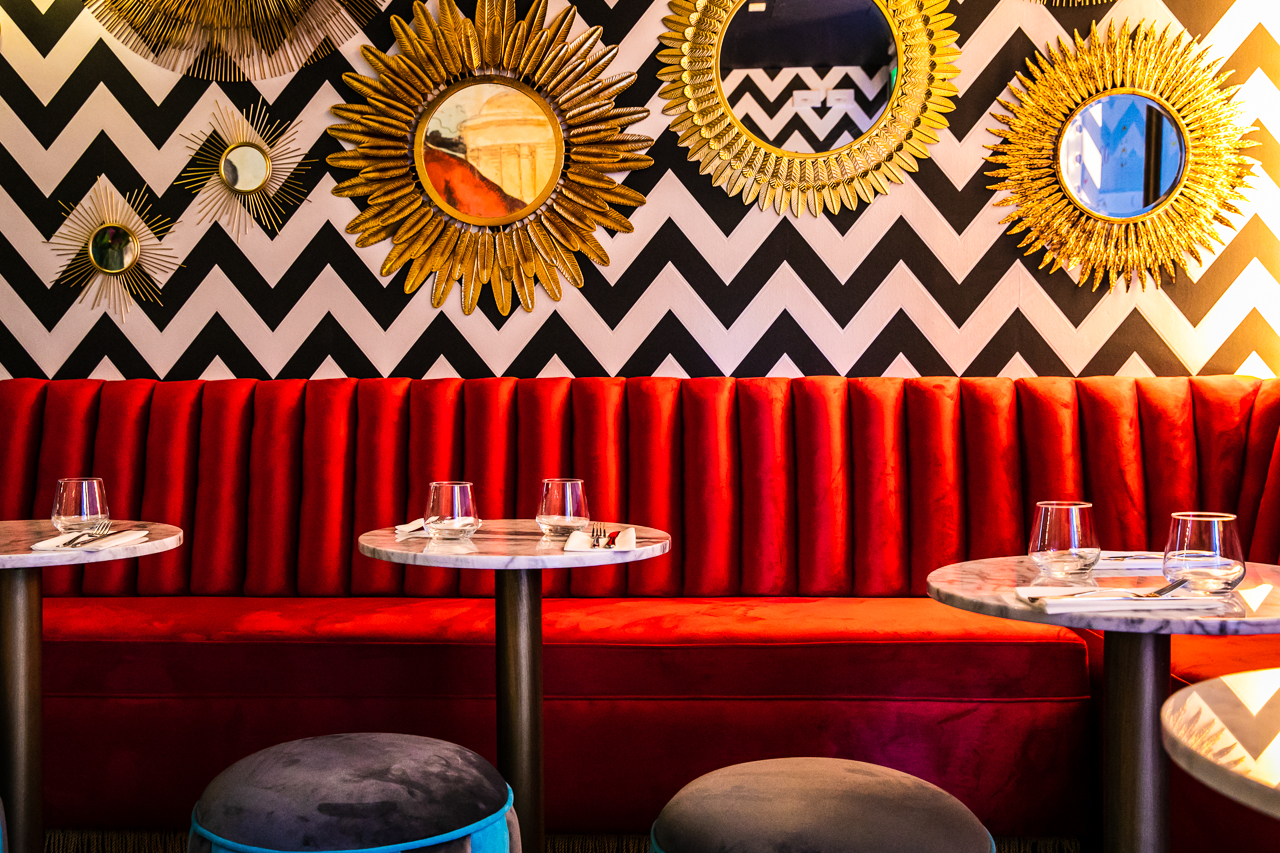 Vibrant seating area with plush red banquette for networking events and gatherings.