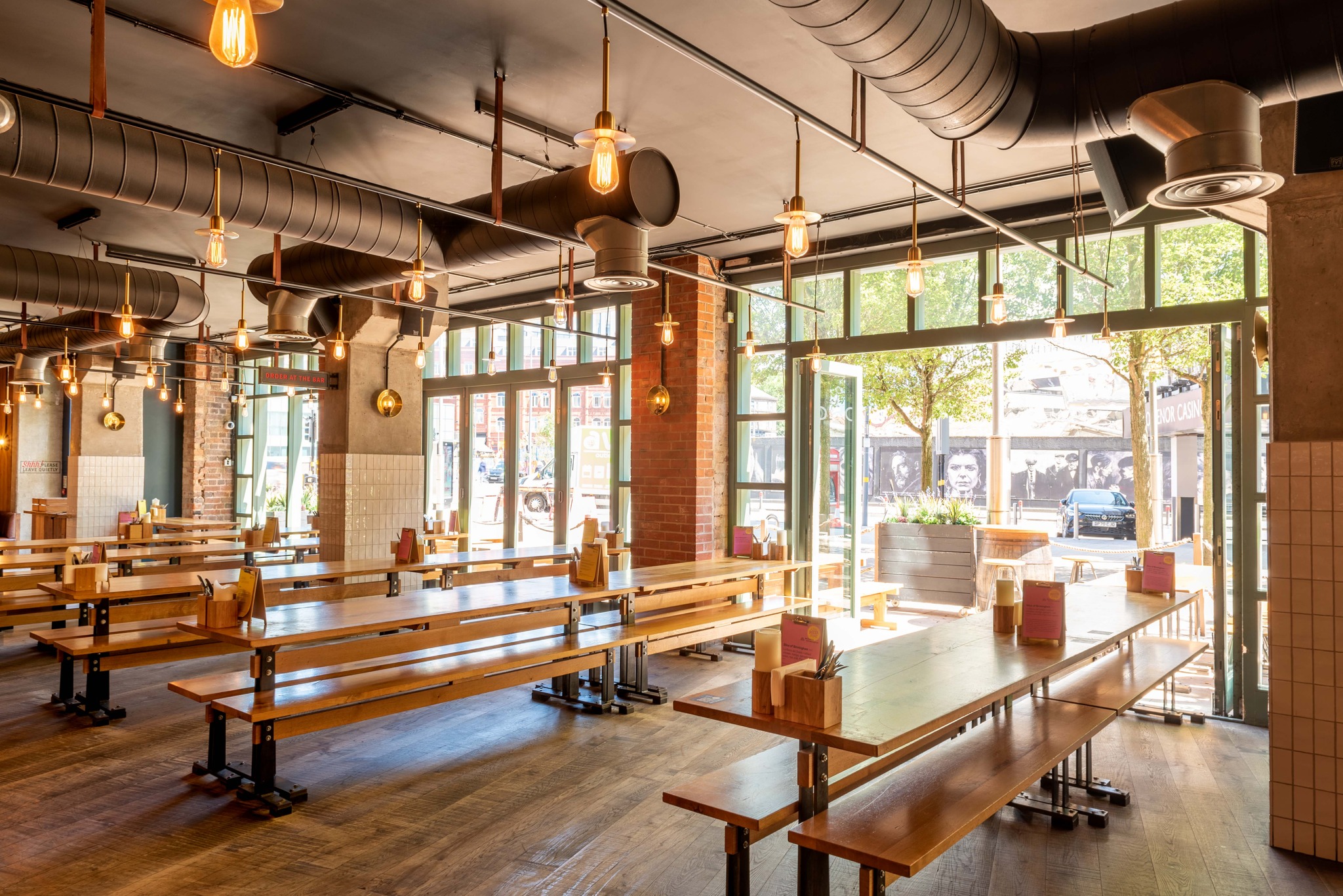 Spacious Birmingham Stable venue with communal tables, ideal for networking events.