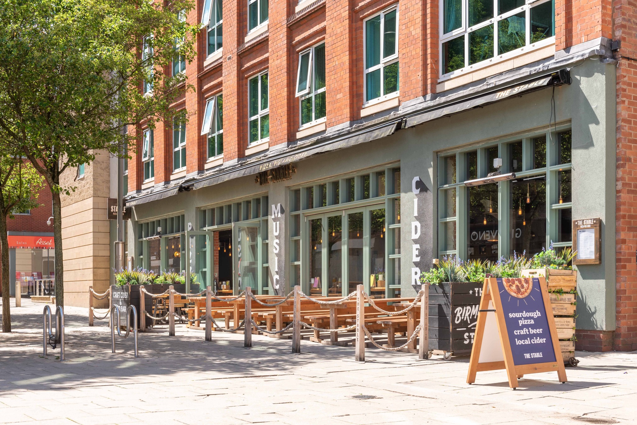 Vibrant Birmingham Stable venue with outdoor seating for casual meetings and networking events.