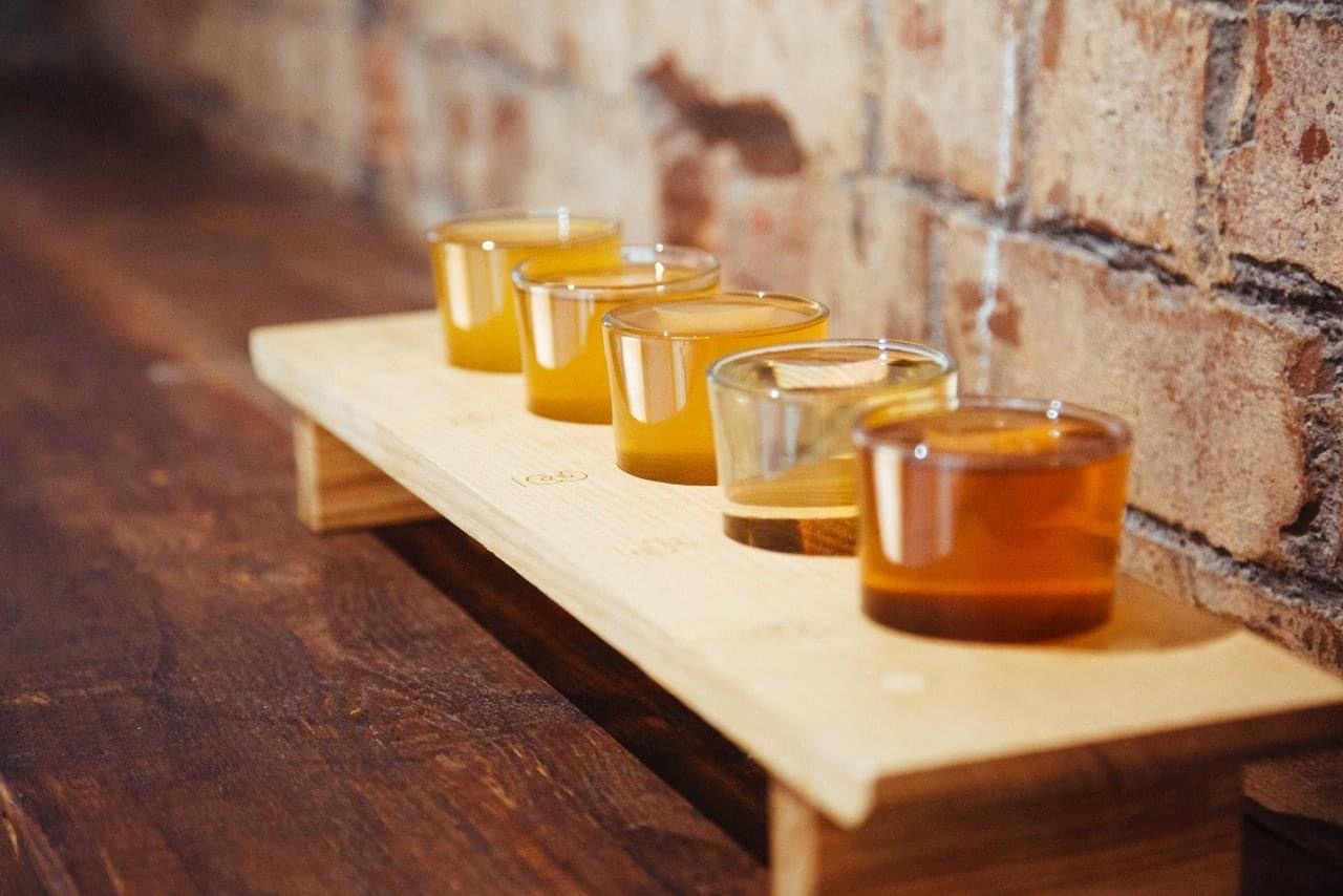 Cider Snug tasting flight on rustic board, perfect for networking events in Birmingham.