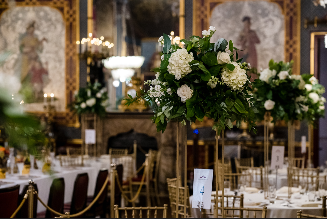 Elegant Banqueting Room in Royal Pavilion with tall floral centerpieces for upscale events.