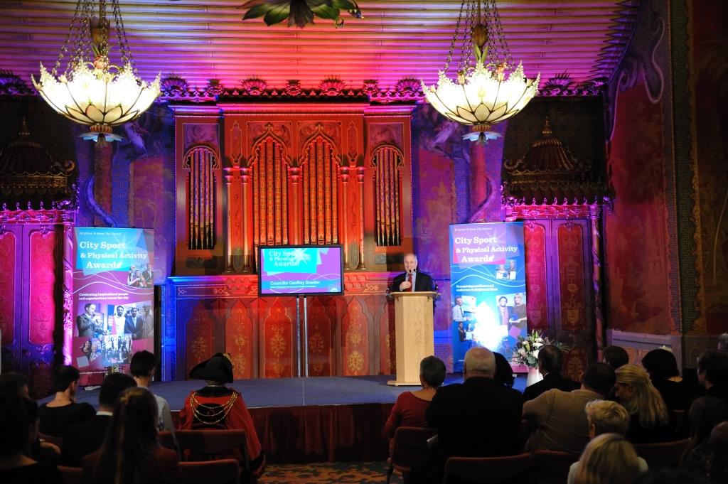 Royal Pavilion Music Room with speaker at podium, ideal for conferences and presentations.
