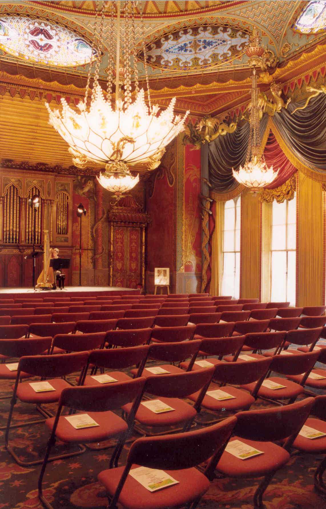 Ornate Royal Pavilion music room, elegant chandeliers, ideal for concerts and events.