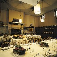 Great Kitchen in Royal Pavilion, elegant round tables set for intimate gatherings and events.