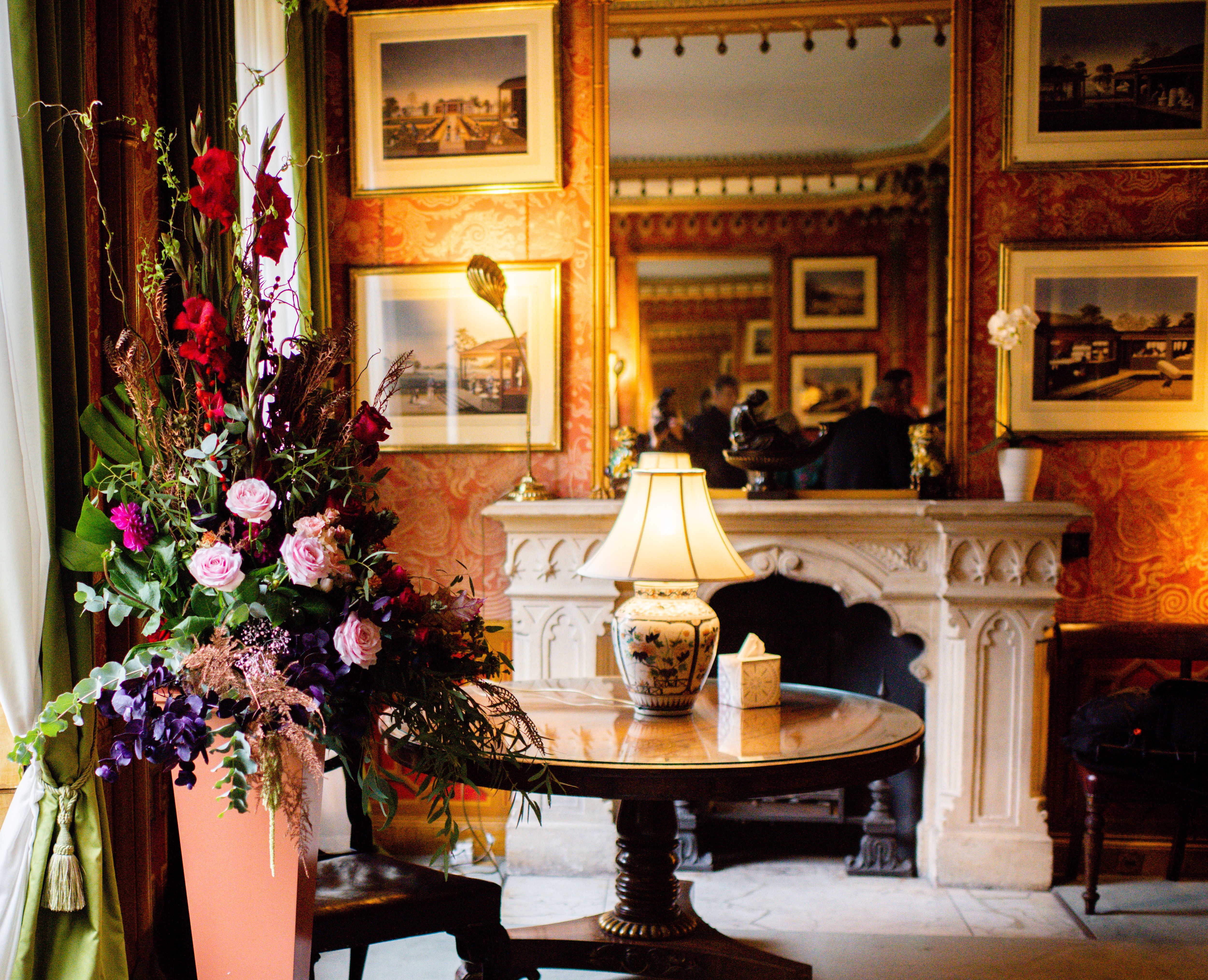 Red Drawing Room at Royal Pavilion, elegant floral display, ideal for upscale events.