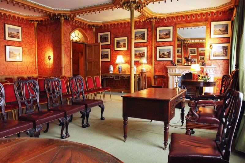 Red Drawing Room in Royal Pavilion, elegant decor for meetings and presentations.