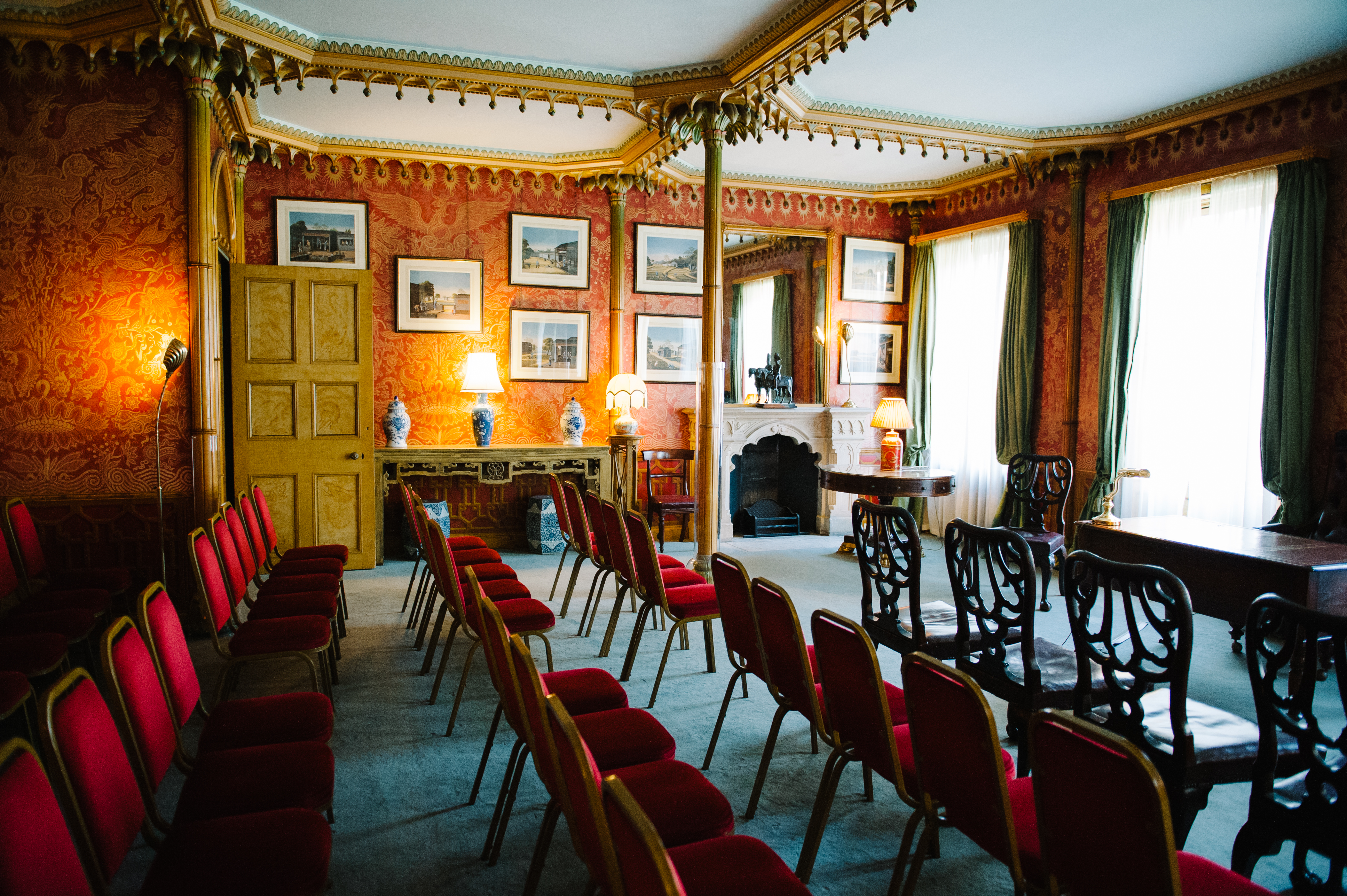 Red Drawing Room in Royal Pavilion, elegant decor for meetings and events.