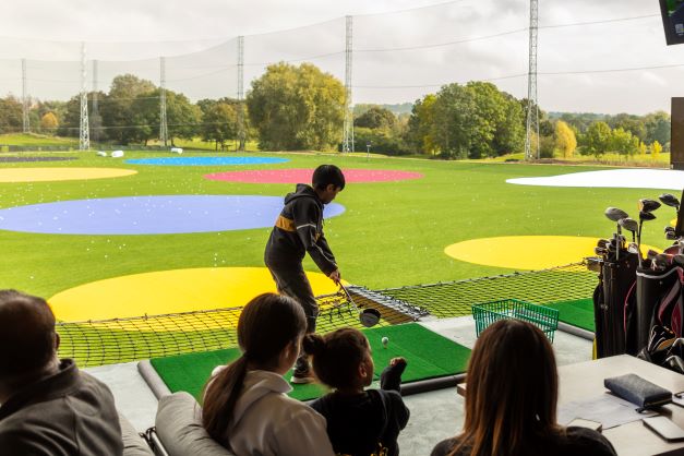 Vibrant golf driving range at Big Shots Golf UK for corporate events and team-building.