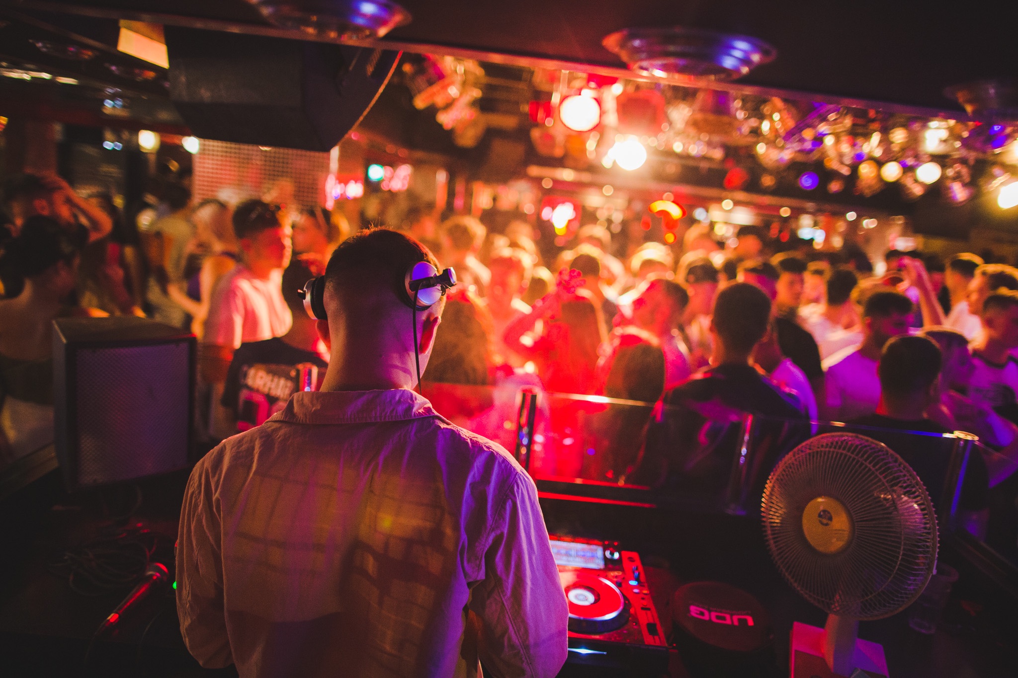 DJ at Pryzm Brighton, vibrant nightlife event with colorful lighting and packed dance floor.