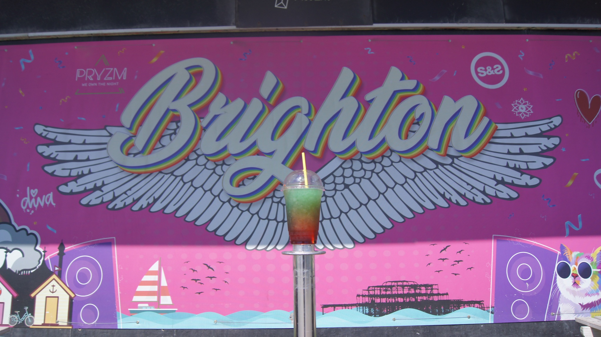 Steinbeck and Shaw at Pryzm Brighton with colorful wings backdrop for lively events.