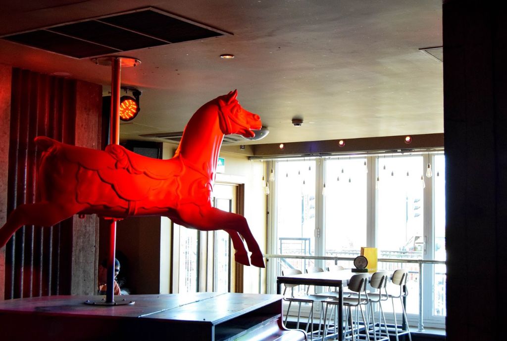 Steinbeck and Shaw at Pryzm Brighton with red horse sculpture, perfect for creative events.