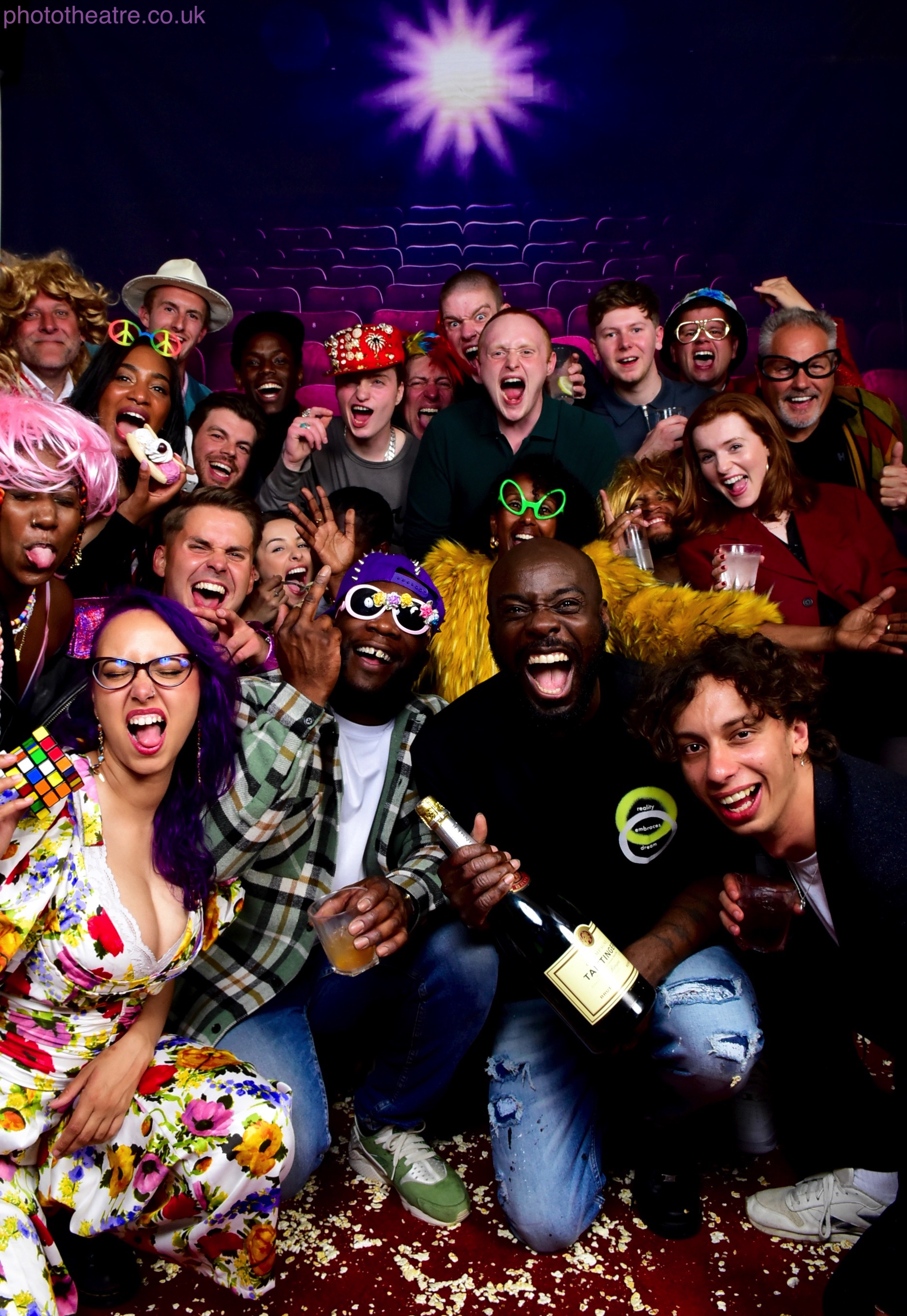 Vibrant group in colorful costumes at a themed event celebrating creativity and inclusivity.