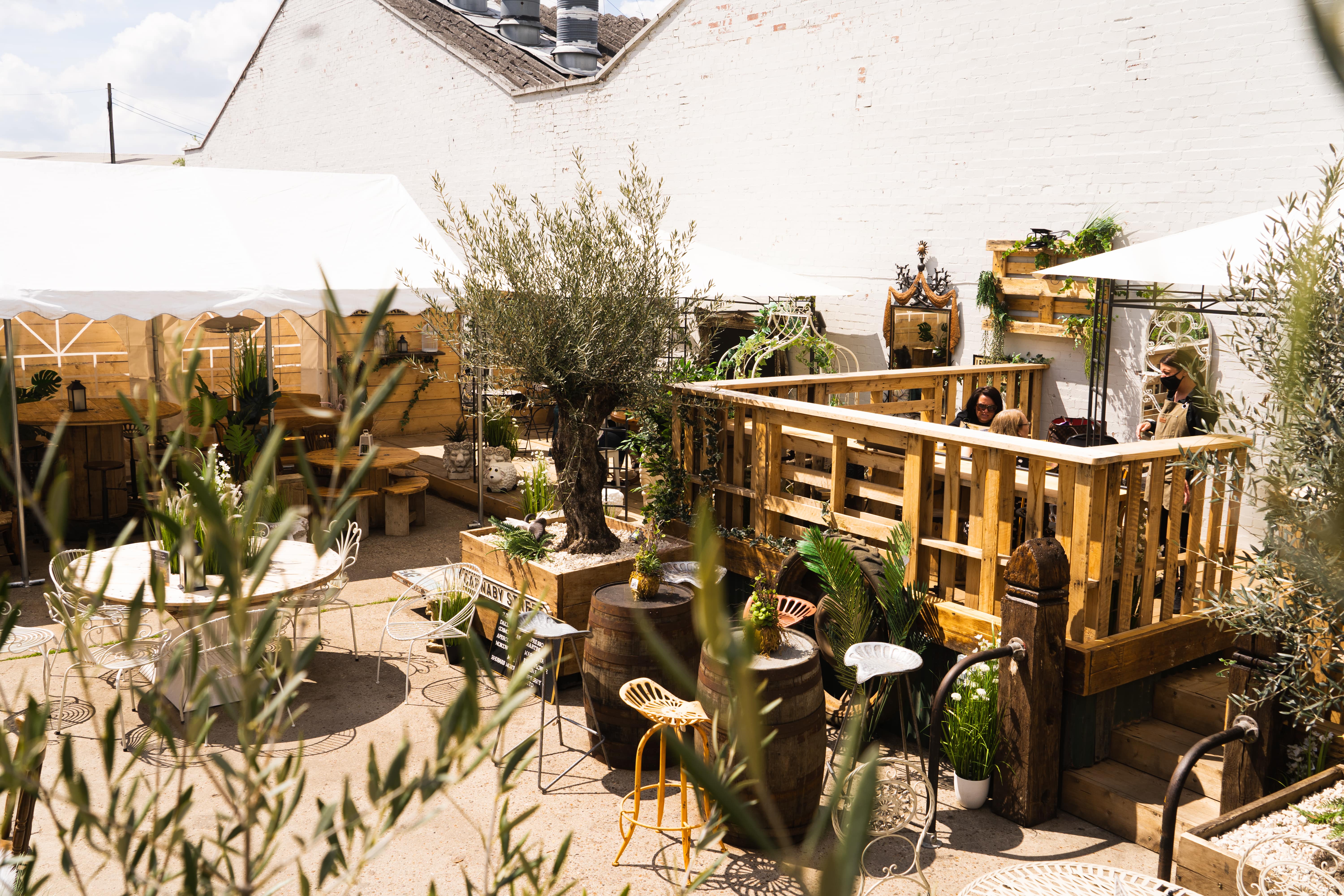 Charming outdoor event space with wooden structures for casual gatherings and networking.