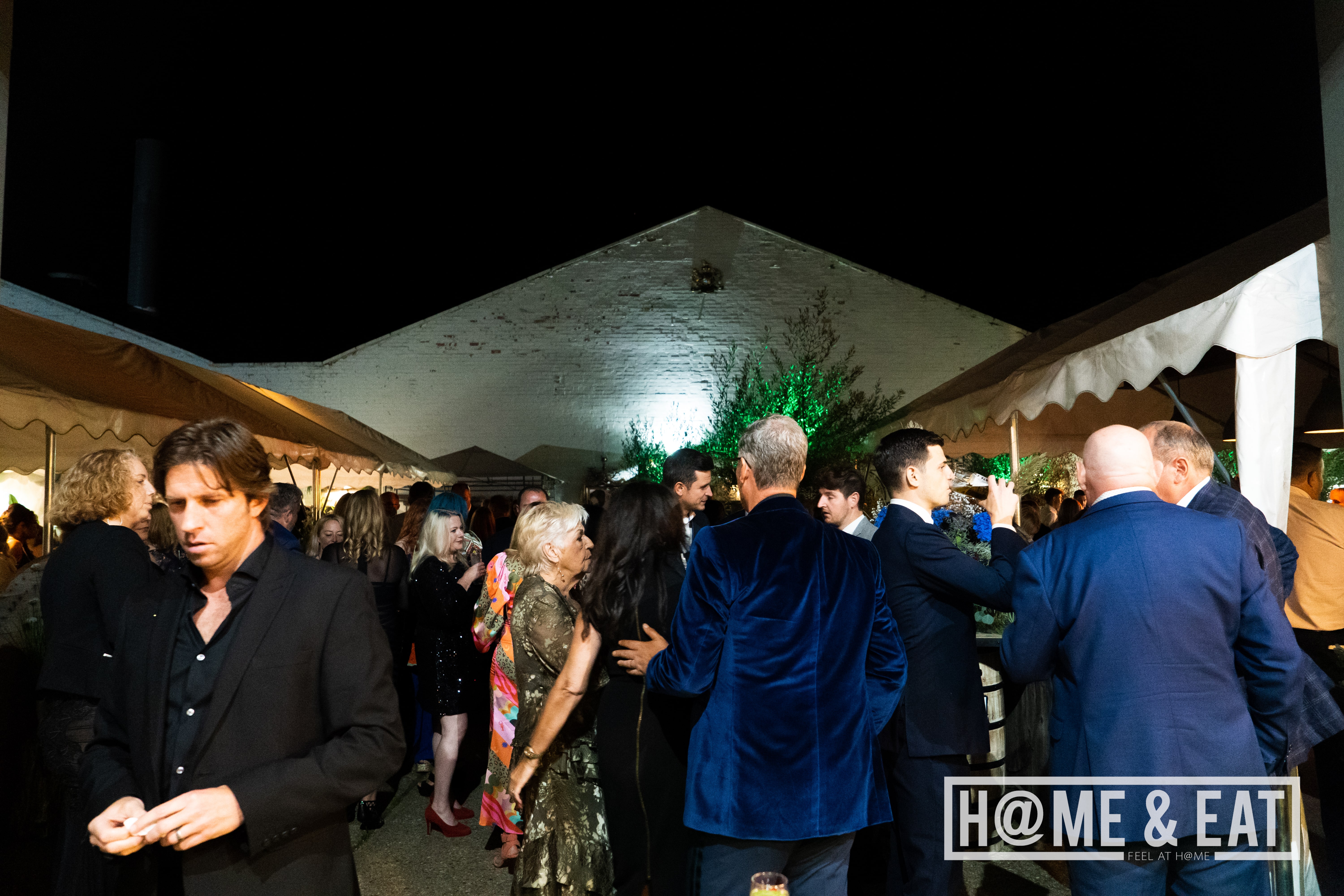 Outdoor gala at The Y@RD with elegant attire and inviting ambiance for networking.