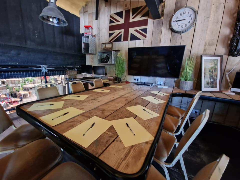 Office & Lounge with rustic table, ideal for meetings and brainstorming sessions.