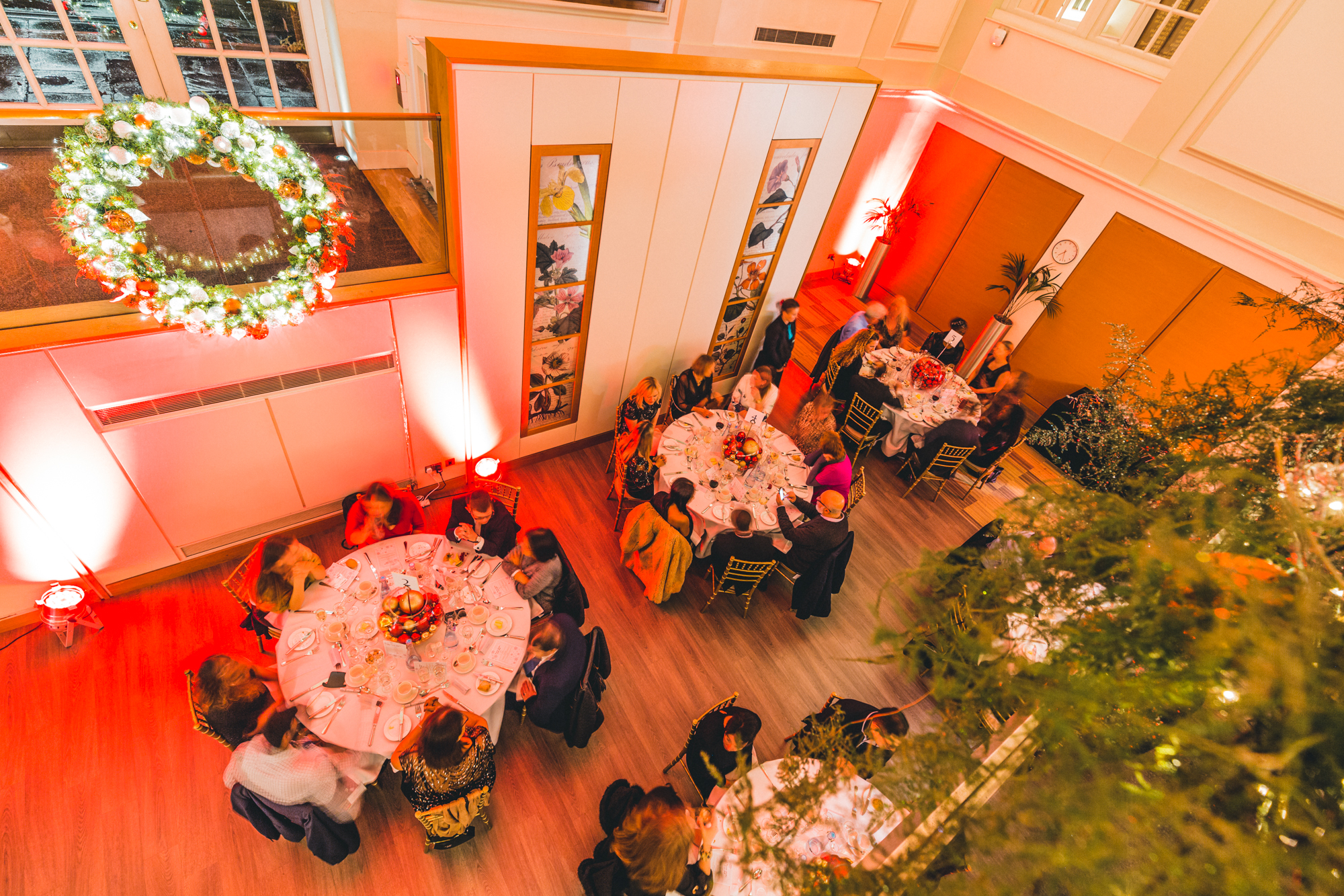 "Elegant Christmas party at BMA House with round tables and festive decor."
