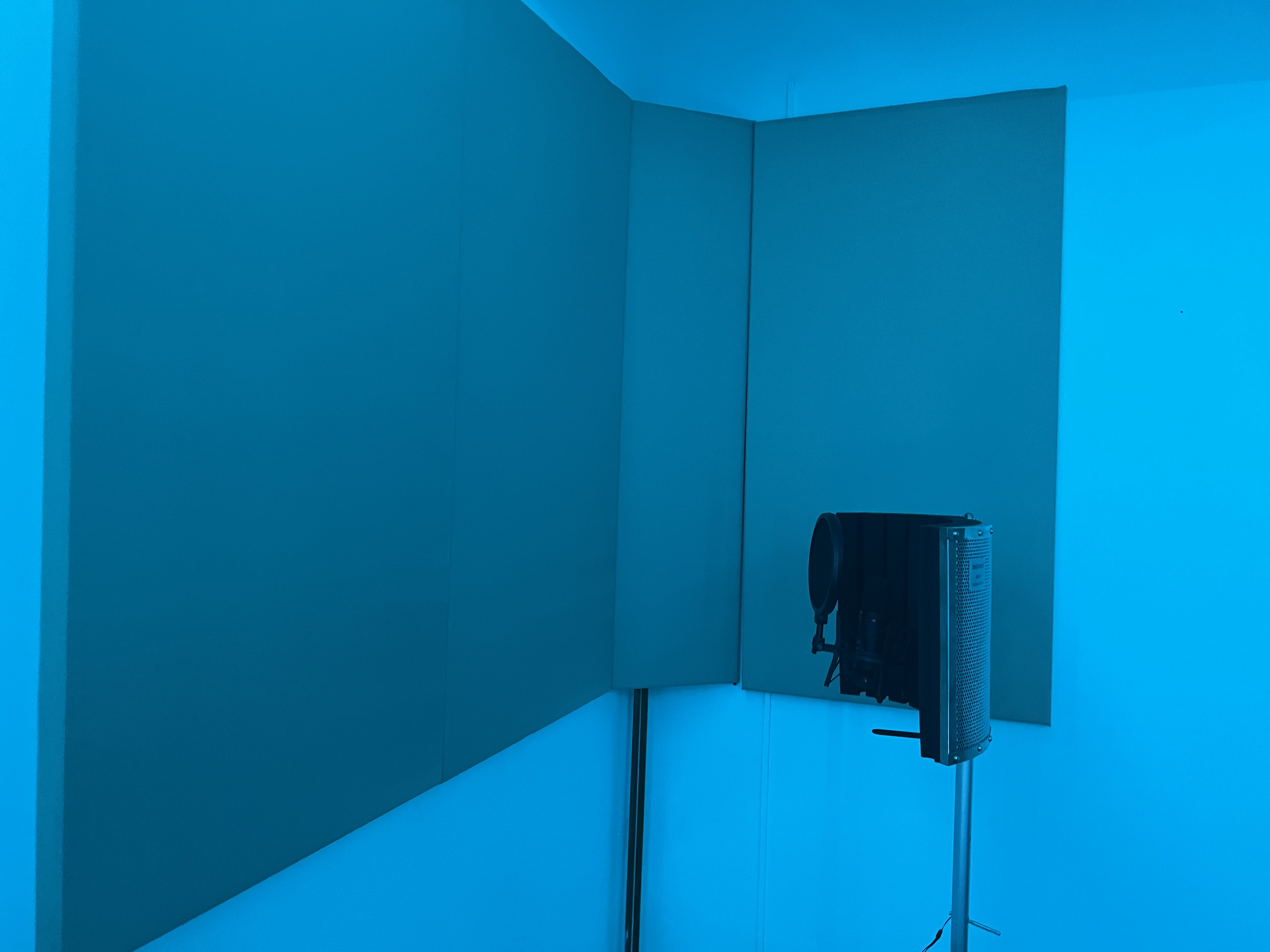 Minimalist music recording studio with sleek microphone setup, ideal for virtual meetings.