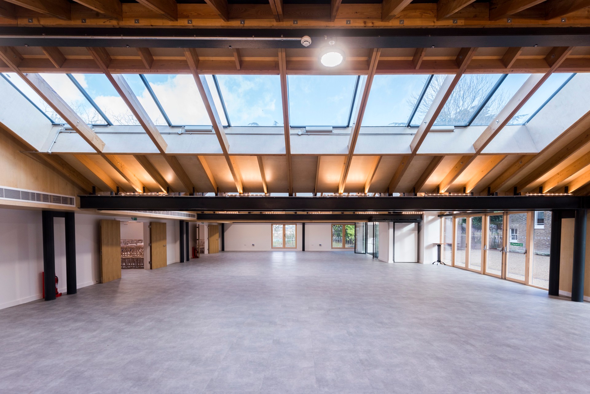 Spacious Orchard Room venue with skylights for conferences and social events.