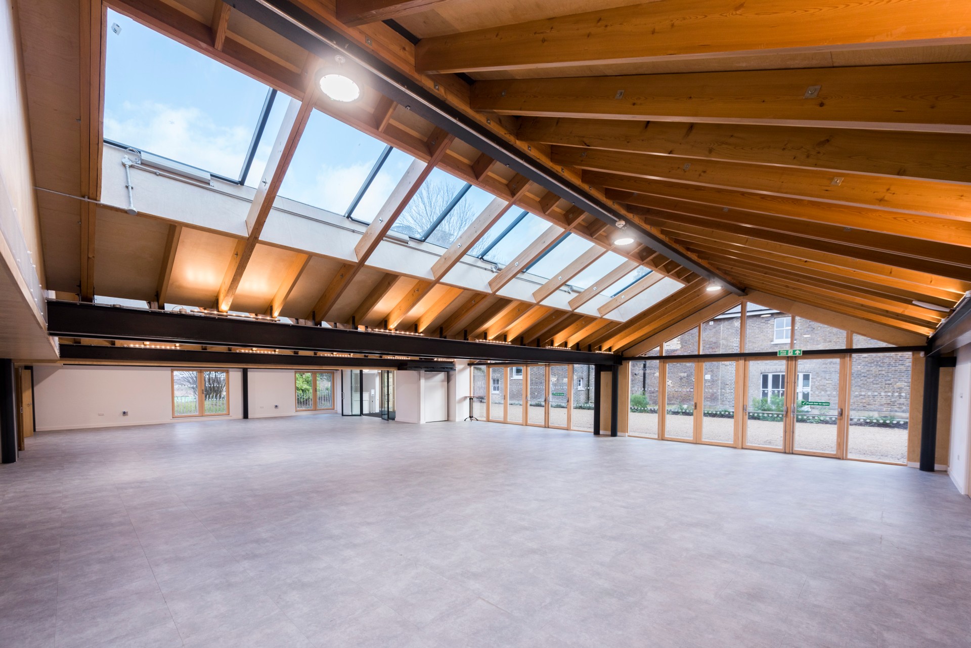 Spacious Orchard Room with wooden beams, ideal for meetings and workshops.