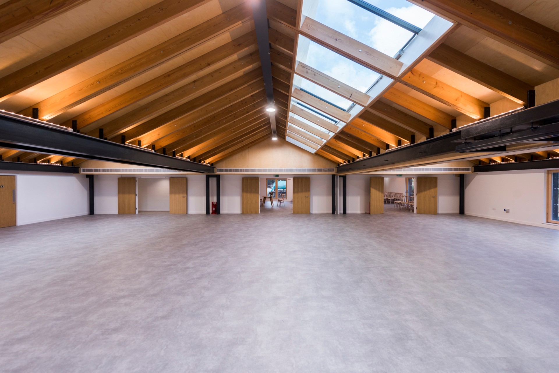 Spacious Orchard Room with high ceilings, perfect for conferences and workshops.