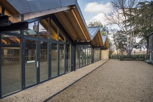 Modern Orchard Room in The Glass House, featuring large windows for events and gatherings.