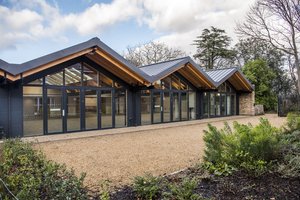 Modern event space with large glass windows, ideal for corporate meetings and gatherings.