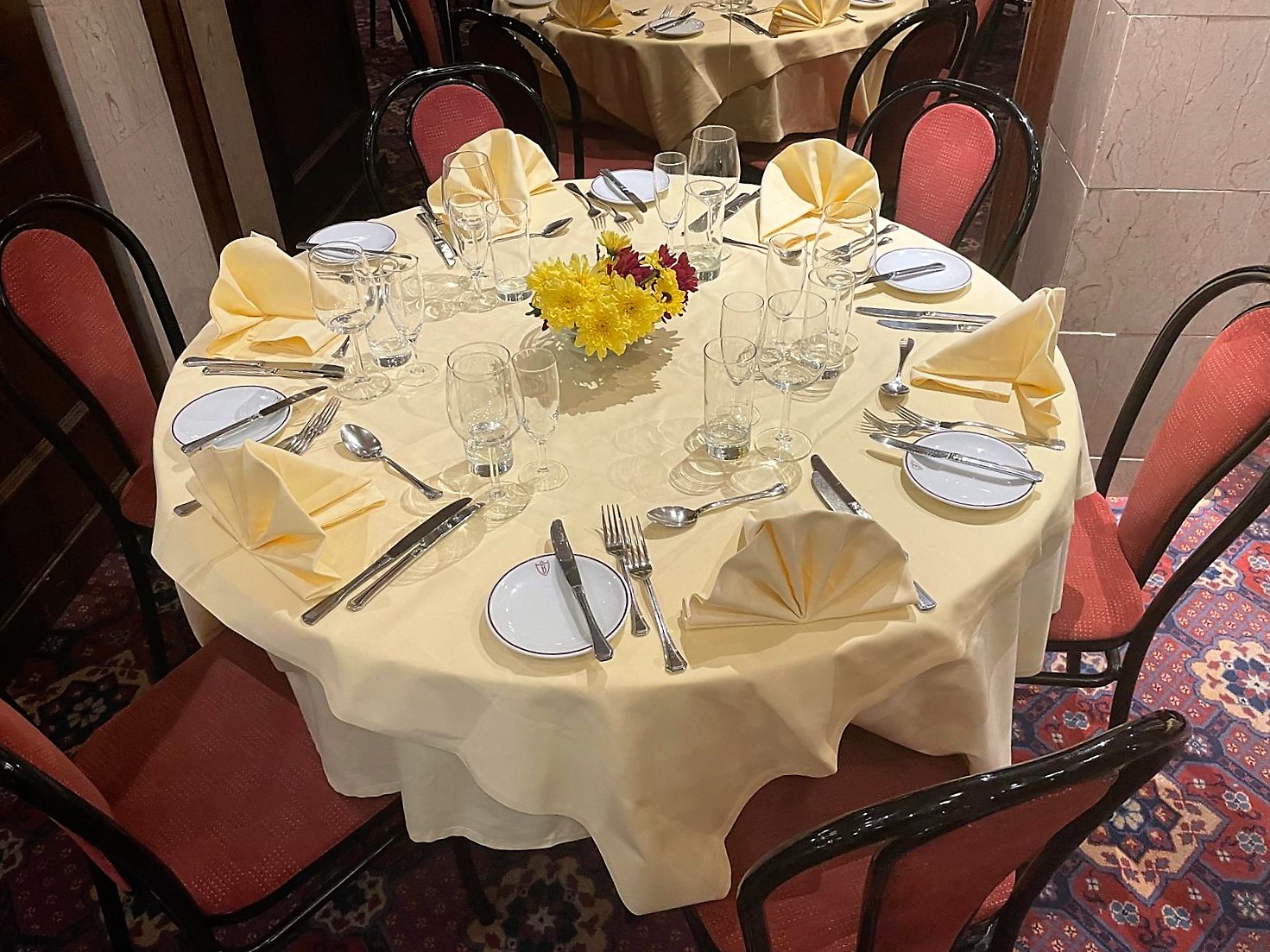 Elegant round dining table set for Christmas event at Bolton's Restaurant.