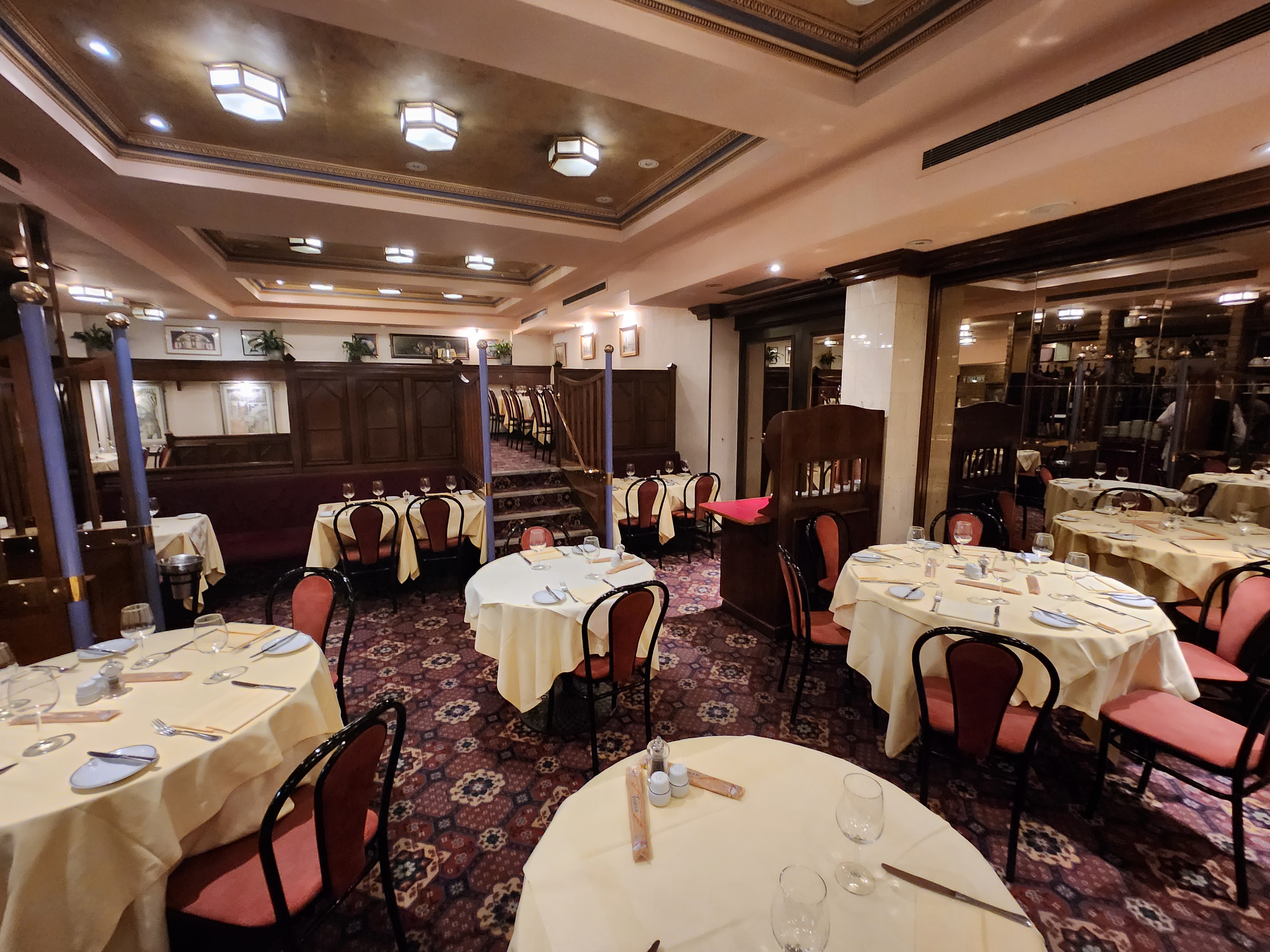 Christmas event at Bolton's Restaurant with elegant yellow tablecloths and cozy seating.