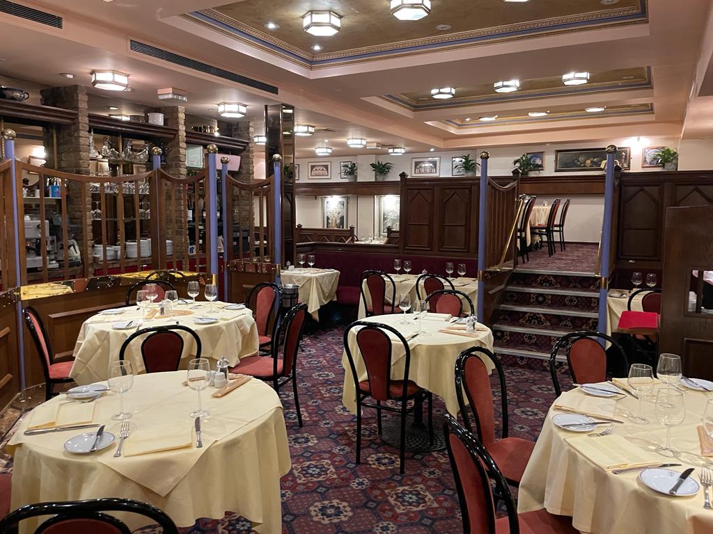 Elegant dining space with yellow linens for Christmas events at Bolton's Restaurant.