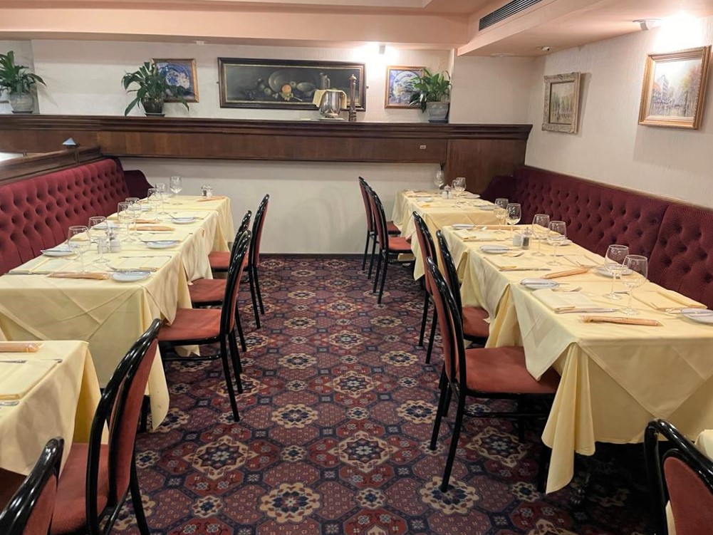 Cozy dining space with yellow tablecloths for intimate Christmas gatherings at Bolton's Restaurant.