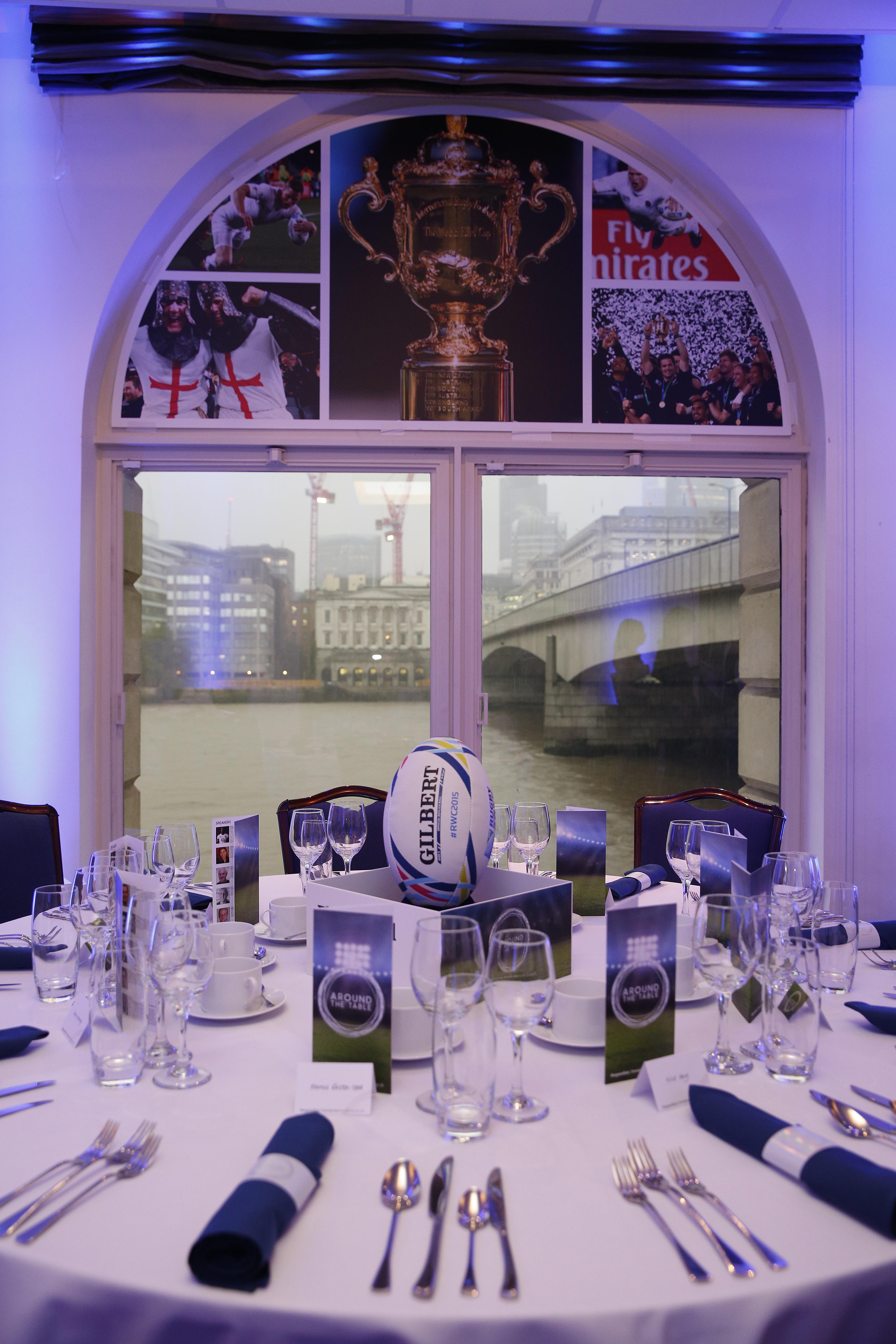 Elegant dining table with rugby ball centerpiece at Glaziers Hall for upscale events.