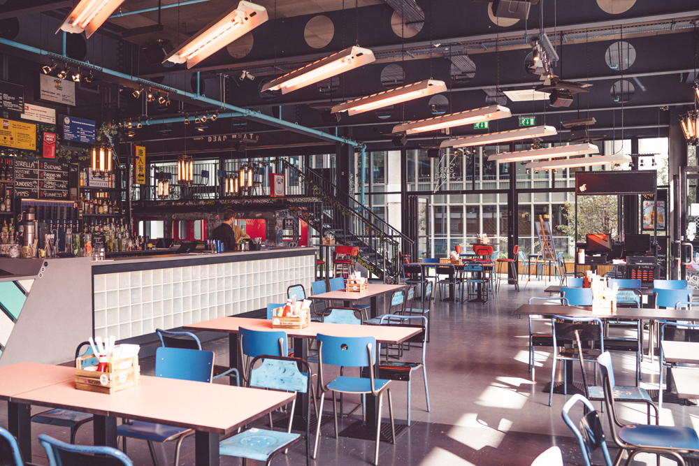 Modern open-concept venue in HUCKSTER London, ideal for networking events and casual meetings.
