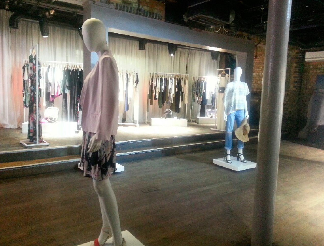 Stylish event space at Egg LDN for a fashion showcase with elegant drapery and mannequins.