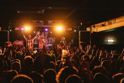 Vibrant live music event at Castle & Falcon with energetic crowd and electrifying atmosphere.