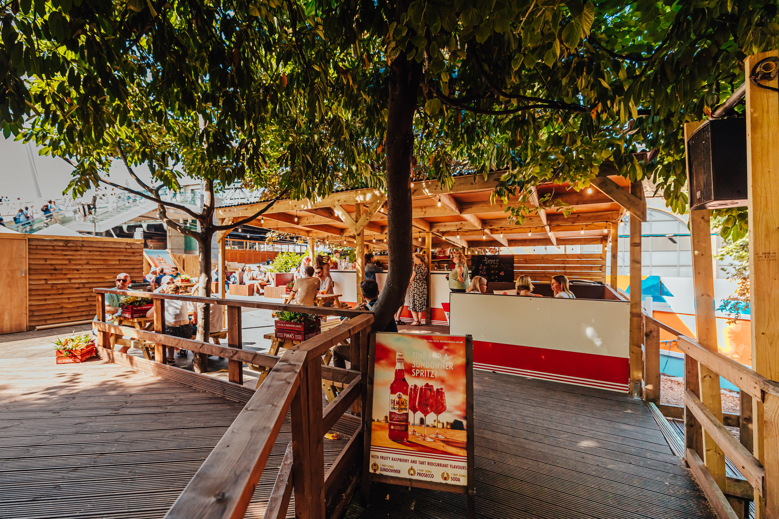 Vibrant outdoor event space with bar, perfect for summer gatherings and festivals.