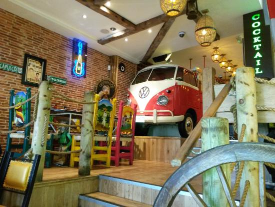 Vibrant event venue with unique Volkswagen bus, ideal for gatherings and celebrations.