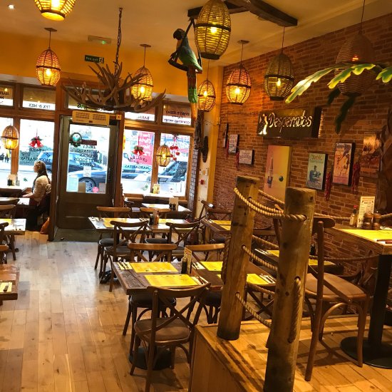 Cozy rustic venue with warm lighting, perfect for intimate meetings and gatherings.