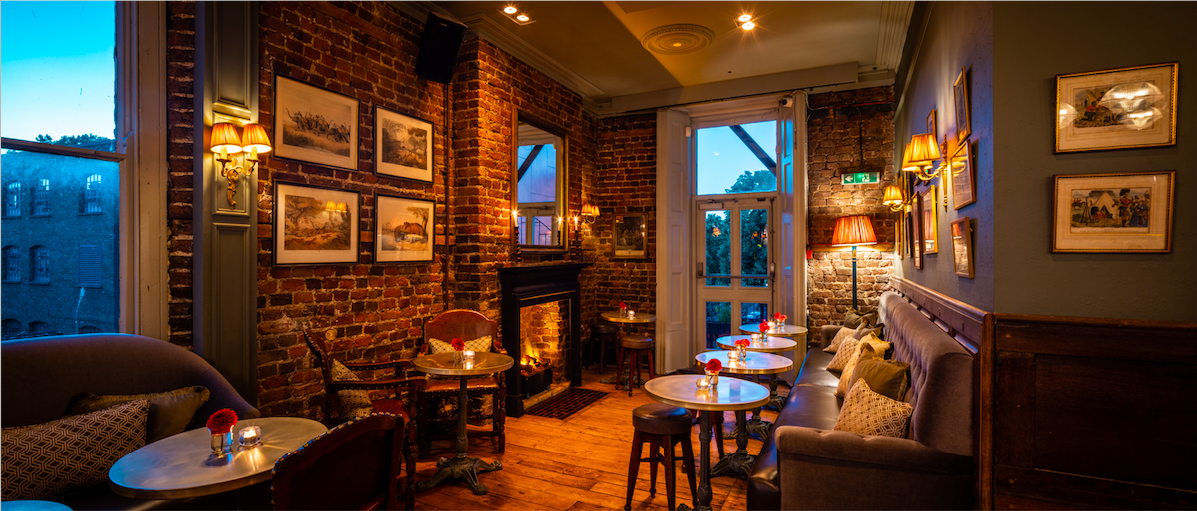 Cozy Cocktail Lounge with rustic brick walls, perfect for intimate gatherings and networking events.