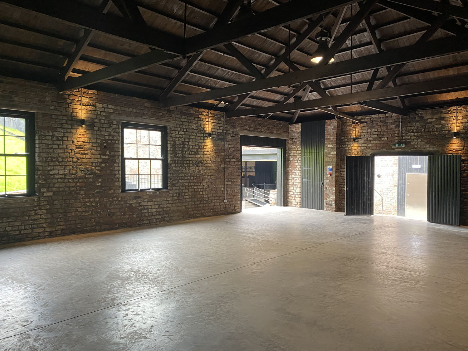 Versatile event space with exposed brick walls, ideal for workshops and receptions.