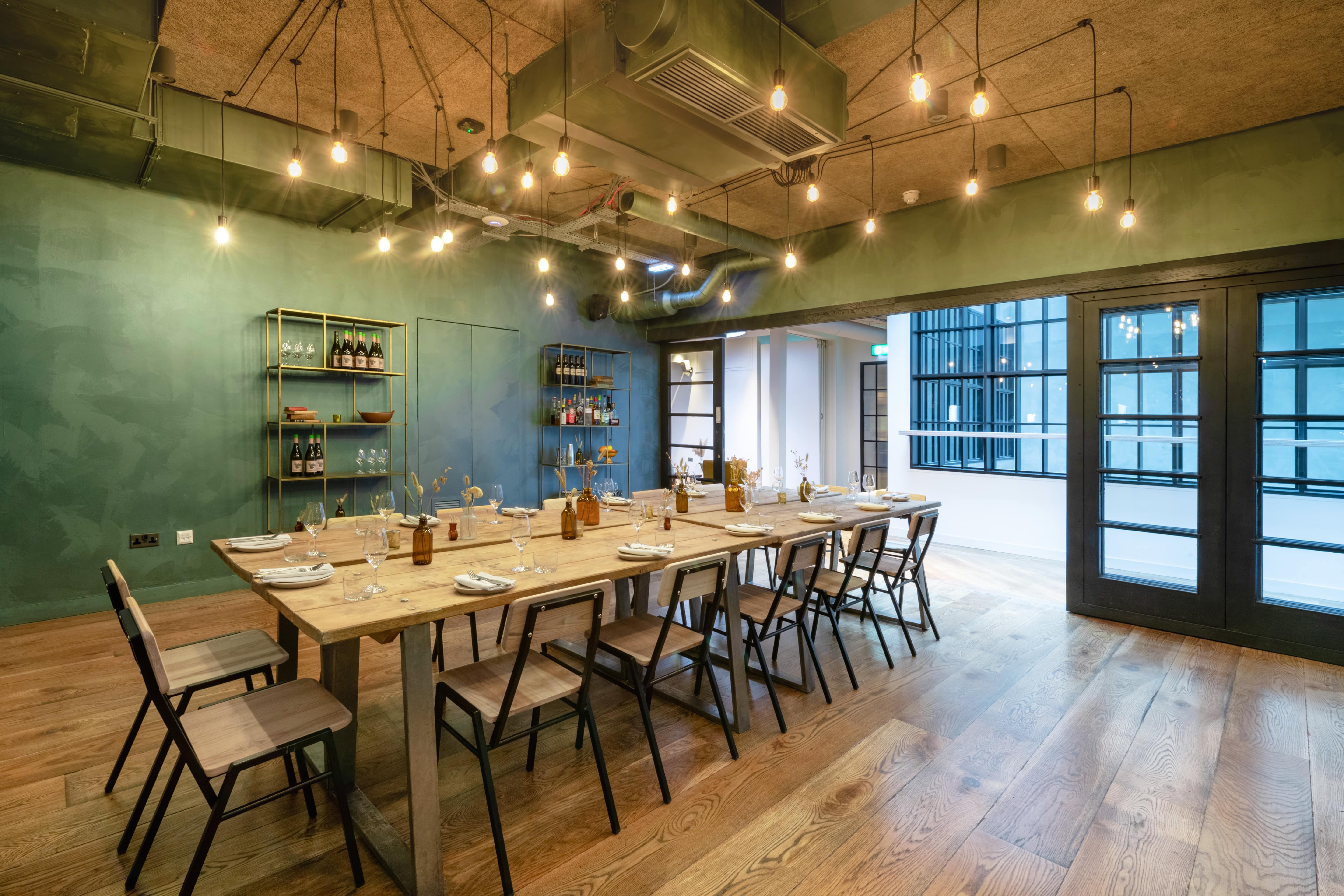 Modern meeting space in Carousel London with a long wooden table for workshops.