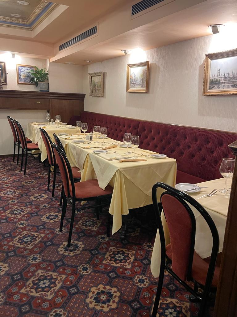 Semi-private dining area in Bolton's Restaurant with yellow linens for intimate events.